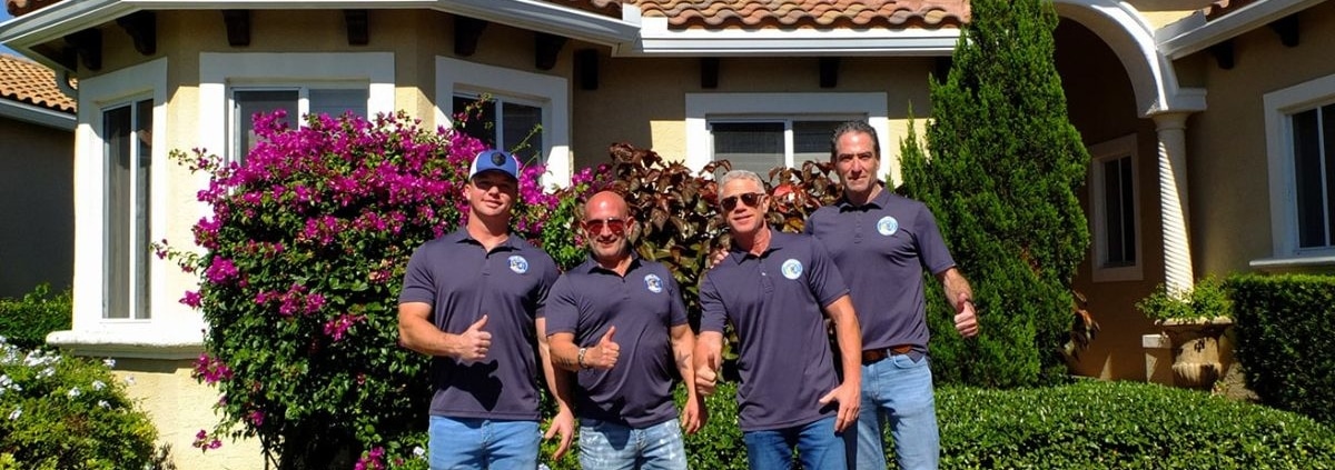 Good Guy Roofing team standing in front of a completed roofing project in South Florida
