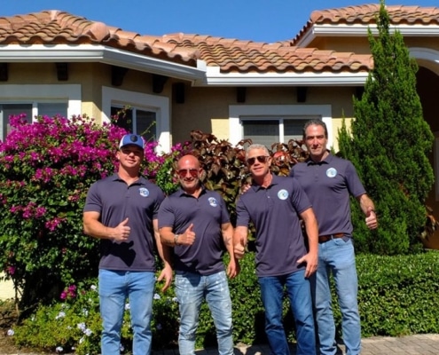 Good Guy Roofing team standing in front of a completed roofing project in South Florida