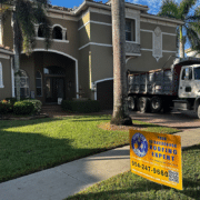 Professional repairing damaged asphalt shingle roof