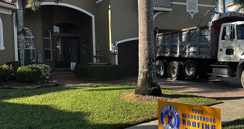 Professional repairing damaged asphalt shingle roof